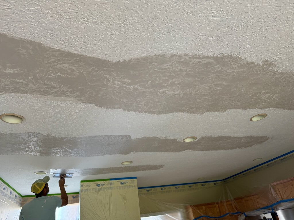 Cornerstone technician repairing a textured ceiling during a drywall project in Westfield, IN.